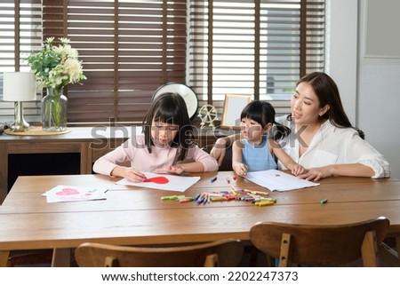 An Asian family with children Drawing and painting on table in playing room at home, Educational game.