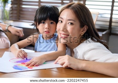Asian family with children Drawing and painting on table in playing room at home, Educational game.