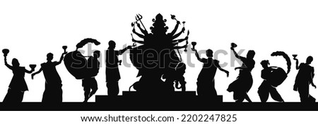 Indian man and women wearing traditional cloth Celebrating Durga puja silhouette by dancing Dhunuchi and drumming  Royalty-Free Stock Photo #2202247825