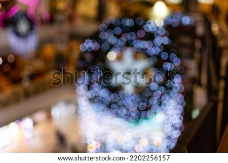 Close up tree Christmas indoor of a shopping mall or department store, background, copy space on left for a design, night light, happy new year concept