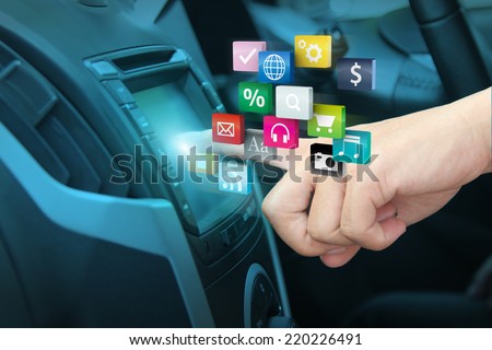 Man using car audio stereo system and pushing on car screen interface, With driver entering cloud of colorful application icon social media networking transportation and vehicle concept idea