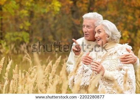 Nice elderly couple in a autumn park. High quality photo