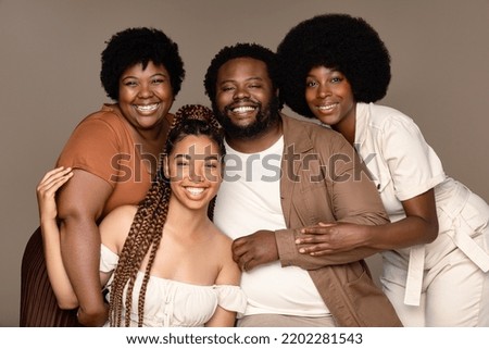 Portrait of a group of gorgeous multiracial people smiling together on a neutral background. Royalty-Free Stock Photo #2202281543