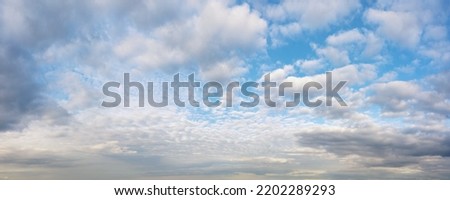 Bright colored idyllic cloudy sky at the horizon. Aerial panoramic view for natural texture and background Royalty-Free Stock Photo #2202289293