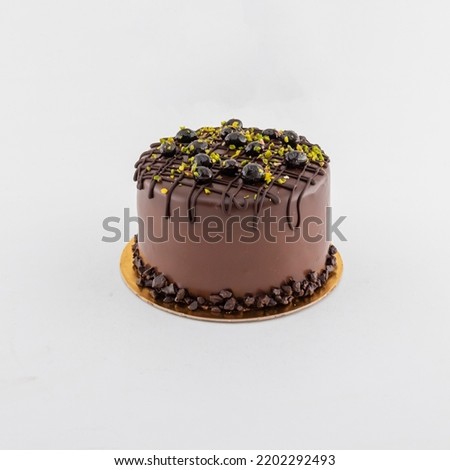 with pistachio and chocolate decorative cake image of birthday cake isolated on white background side view