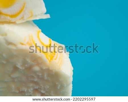 Orange ice cream with white milk chocolate. Ice cream on a blue background.