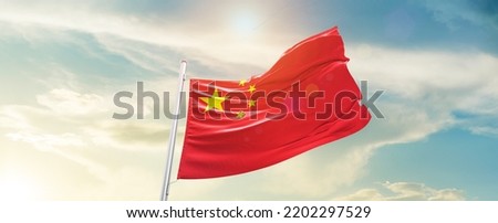 China national flag waving in beautiful sky.