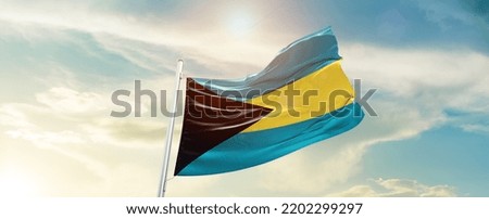The Bahamas national flag waving in beautiful sky.