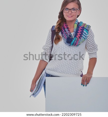 Beautiful student woman pointing on blank board. Student.