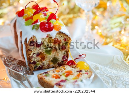 Christmas fruitcake with sugar icing and candied fruits