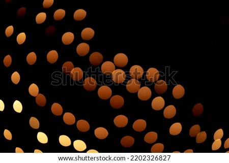 Isolated black background of blurred bokeh with warm golden lights. Overlays for your design. High quality photo