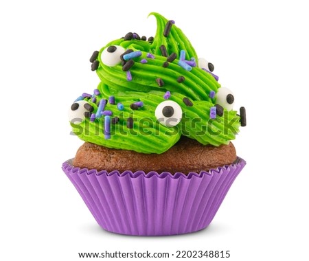 Cupcake. Cupcake on Halloween. Dessert on Halloween party. Chocolate muffin decorated with colored sprinkles, green frosting and Icing. Close-up macro high quality, resolution photo. Isolated on white