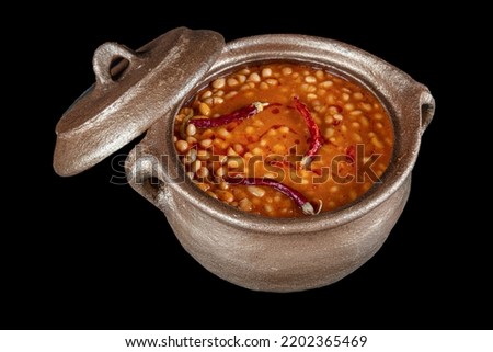 Turkish food Kuru fasulye (navy beans ) in casserole pot on the table. Local traditional foods concept with top view. Royalty-Free Stock Photo #2202365469