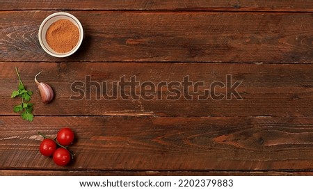 Kitchen background with ingredients,minimal cooking concept,business card for restaurant,cafe,shop,menu,tomatoes,garlic,greens on wooden table,selective focus,top view,space for text,
