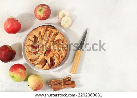 Kitchen background with apple pie, honey, apples, spices, cozy warm concept, hello autumn, hygge style, modern bakery advertisement, selective focus, top view,
