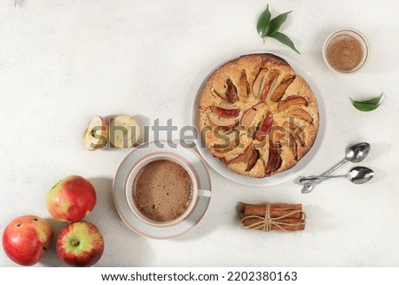 Cozy home table with apple pie and cappuccino coffee, honey, apples,healthy breakfast with ingredients concept hello autumn, hygge style, modern bakery advertisement, selective focus,
