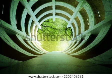 Bottom view multi-story car park building. Multi-level parking lot. Eco-friendly building in modern city. Tree branches with green leaves and sustainable building. Go green. Sustainable development. Royalty-Free Stock Photo #2202406261
