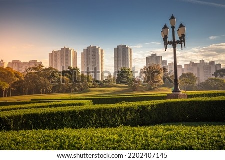 Park Barigui in Curitiba at sunrise with buildings and street light, Brazil Royalty-Free Stock Photo #2202407145