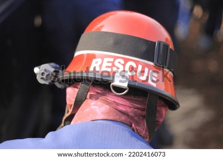 a firefighter wearing a safety helmet with the word rescue on it.