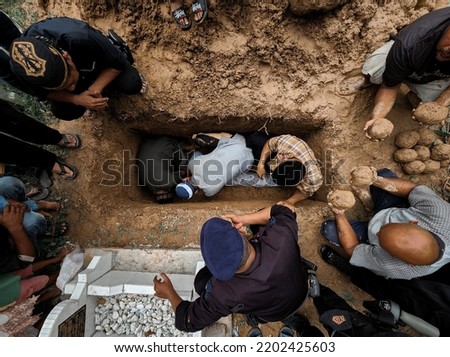 picture of burial procession taken from above. this kind of burial procession is usually taken place in Indonesia as Moslem Tradition. Royalty-Free Stock Photo #2202425603