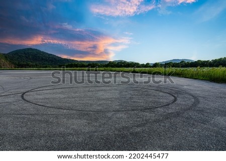 Empty asphalt race track road and mountain with beautiful sky clouds at sunrise