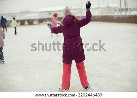 Girl on skates. Winter holidays. Ice skating. Sports details. Exercise on ice. Figure skating.