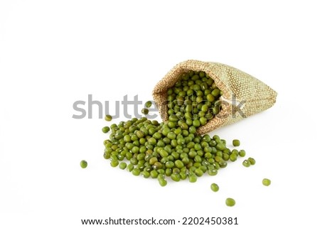 Mung beans or green beans in gunny sack isolated on white background. Royalty-Free Stock Photo #2202450381