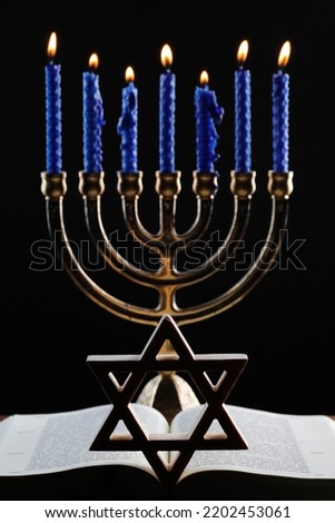Open Torah, star of David  and the menorah or seven-lamp Hebrew lampstand, symbol of Judaism since ancient times.  Royalty-Free Stock Photo #2202453061