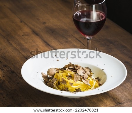 Pasta with fresh truffle mushroom background.Restaurant menu plate copy space. Royalty-Free Stock Photo #2202478821