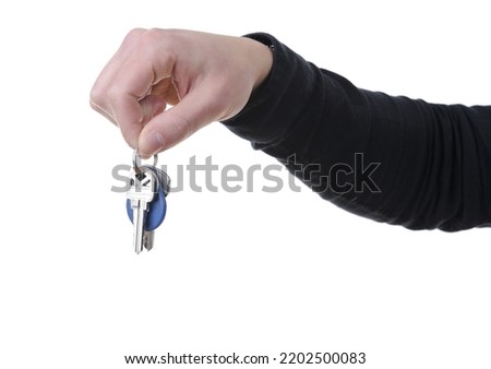 Close-up of a hand holding house keys isolated on white background