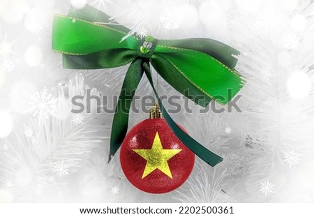 New Year's glass ball with the flag of Vietnam against a colorful Christmas background