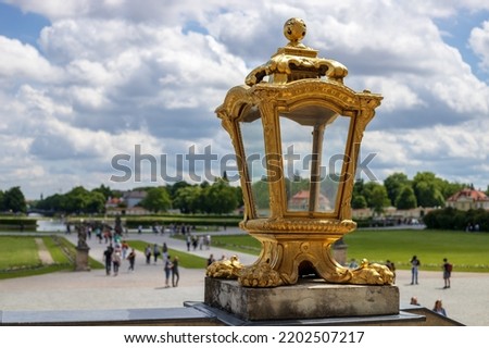Golden lamp and the Nymphenburg Palace promenade in the background.