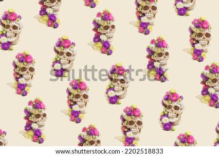 Creative seamless pattern made of realistic human skulls with colorful flowers on pastel beige background. Aesthetic Mexican Day of the Dead (Dia De Los Muertos) or Halloween concept.