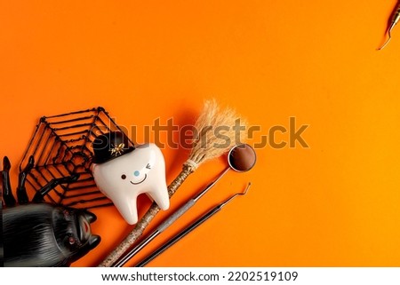 dentistry.dental.halloween. holiday concept. holidays. dentist.character for dentist halloween card.dental concept. figurines of teeth in halloween costumes and dental instruments. pumpkins and broom