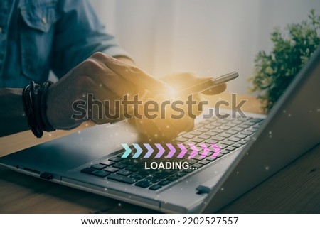 Casual Businessman Touching Mobile Phone or Smart Phone and Turquoise Magenta Fishbone Loading Module and Laptop Computer. Searching or Downloading Concept in Vintage Tone