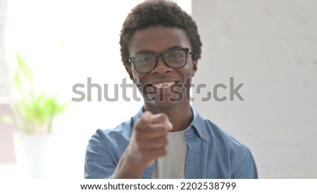 Portrait of Young African Man Pointing at the Camera