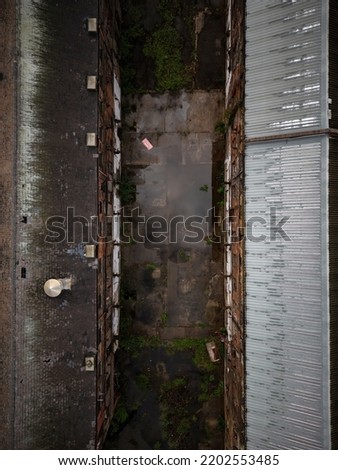 Old generic derelict industrial buildings in a dilapidated state aerial view Royalty-Free Stock Photo #2202553485