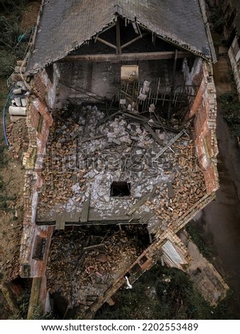 Old generic derelict industrial buildings in a dilapidated state aerial view Royalty-Free Stock Photo #2202553489