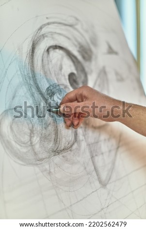 Close-up artist drawing pencil draft on canvas. Designer's hand sketching project. Modern art, creative profession Royalty-Free Stock Photo #2202562479