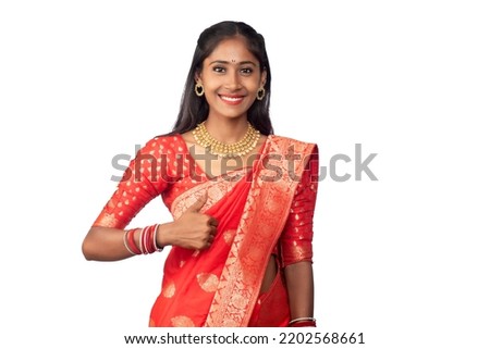 Traditional young smiling girl showing ok sign or thumbs up on a white background