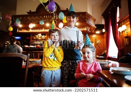 Three children on birthday party. 