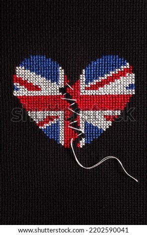 Embroidered broken heart in UK colours.
