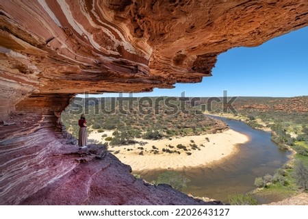 A woman is looking at beautiful gorge of Kalbarri National Park, Western Australia Royalty-Free Stock Photo #2202643127
