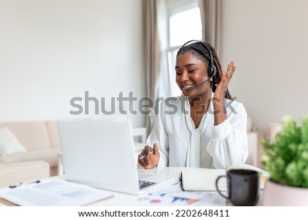 African elegant female entrepreneur discussing while having a conference call Portrait of confident ethnicity female employee looking at camera talking on video call in the home office.