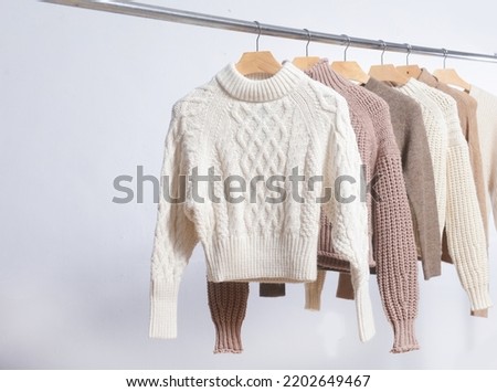 Row of Turtleneck ,sweater close up on hanger on the gray background Royalty-Free Stock Photo #2202649467