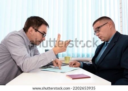 business people and lawyers discussing contract sitting at the table. man chief is signing papers. Business communication in office. Hiring an employee to work. Persuasion to sign a contract