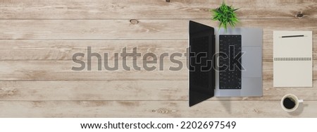 Flat lay of top view desk work table with computer notebook and pencil work space on wood background includes copyspace for add text or graphic