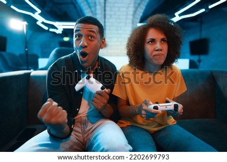 The guy won the game. The friend is upset. High quality photo Royalty-Free Stock Photo #2202699793