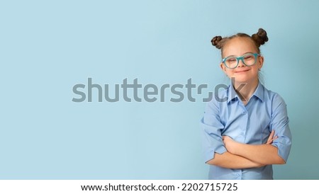 Happy girl with Down syndrome having fun and laughing in the studio. Banner Royalty-Free Stock Photo #2202715725