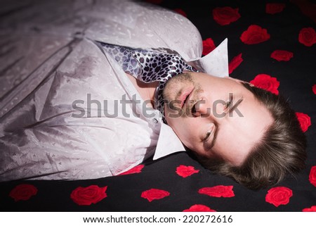 Corpse of business man lays on a bed